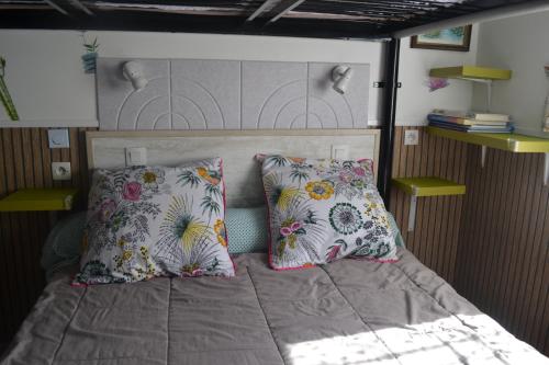 a bed with two pillows on it in a bedroom at la PASSERONNE in Barbentane
