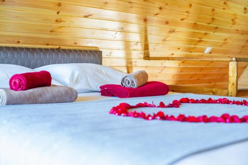 a bed with red and white pillows on it at Veranda Buknari in Buknari