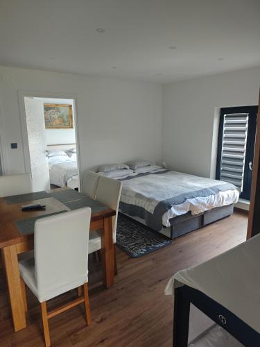 a bedroom with a bed and a table and chairs at Apartman Zara in Krapina