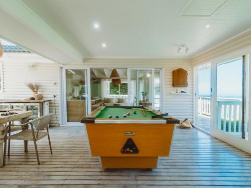 a living room with a pool table in it at Sun and Sea Glentana in Glentana