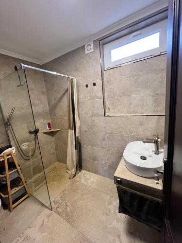 a bathroom with a shower and a sink at KörösPartOn in Békésszentandrás