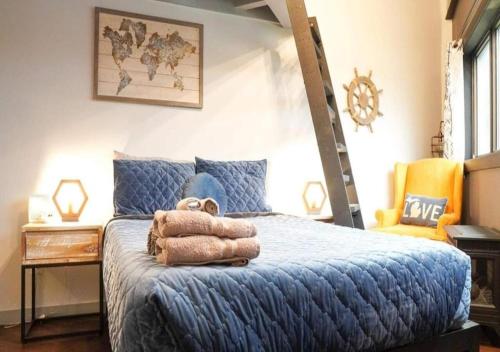 a bedroom with a blue bed with a ladder at Rivers Edge Lofts - Unit 4 in Niles