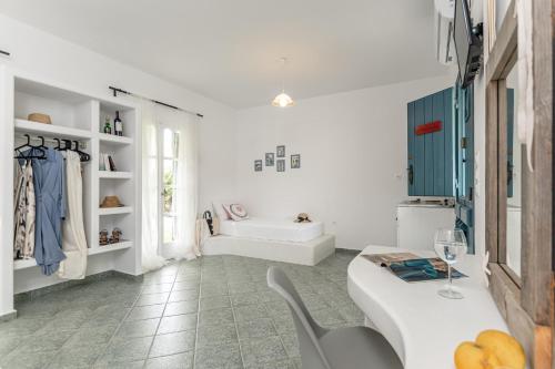 a white room with a table and a chair at Palatiana Agriturismo-Philoxenia Cottages Retreat in Galini