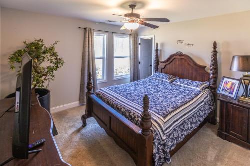 a bedroom with a bed and a ceiling fan at Hideaway Getaway in Statham