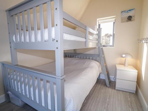 a bedroom with two bunk beds and a ladder at Cabin 5 Eargail in Gortahork