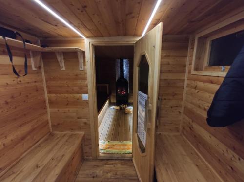 a small wooden room with a fireplace in a wooden house at Vikos-Spa in Rzeczyca
