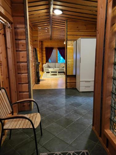 a living room with a refrigerator and a couch at Huvila Vuosselin Nuppu in Kuusamo