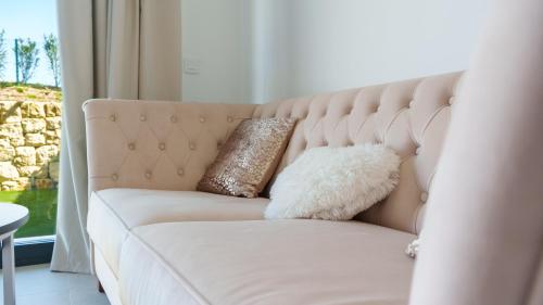 a couch with two pillows on it in a living room at CAMPOROSSO magic apartment in Finestrat