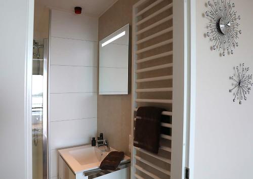 a bathroom with a sink and a mirror at Floatinghouse Bernstein Suite in Ribnitz-Damgarten