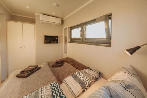 a bedroom with a bed with a blanket on it at Floatinghouse Enola in Fürstenberg