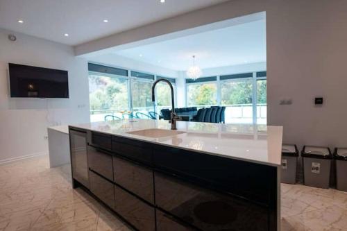 a large kitchen with a large island in a room at Villa Boomerang in Srbljani
