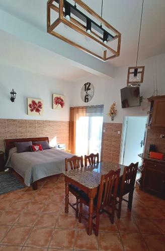 a bedroom with a bed and a table with chairs at Bela Vista in Paradela