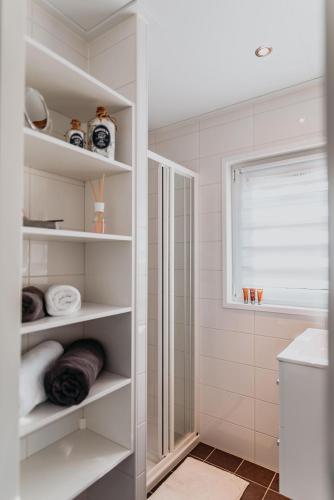a bathroom with white shelves and a sink at Floatinghouse Möwe 4 - LP4 in Vetschau