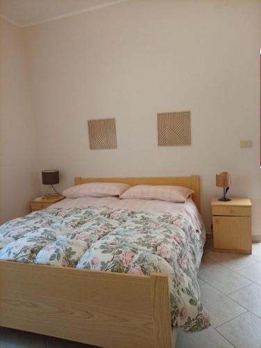 a bedroom with a bed and two night stands at a casa di Norma in Bronte