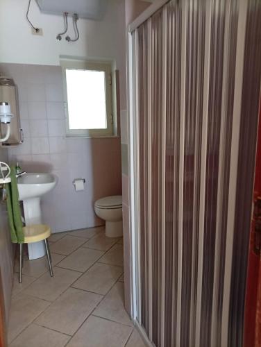 a bathroom with a shower and a toilet and a sink at a casa di Norma in Bronte