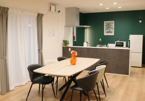 a dining room with a table and chairs at 新築貸し切り宿 Karatsu House B in Karatsu