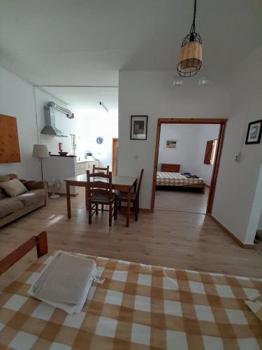 a living room with a table and a couch at Casa Fonte in Santo Estêvão
