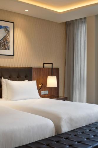 a hotel room with a bed and a lamp at Eurostars Avenue Louise in Brussels
