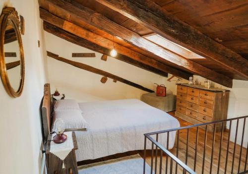 a bedroom with a bed and a wooden ceiling at S'Ispera B&B, Home Restaurant, Autentiche Esperienze Sarde in Fonni