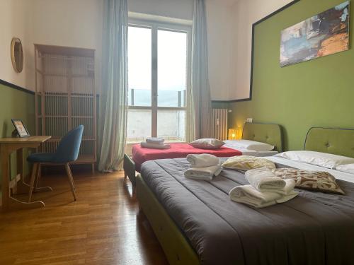 a hotel room with two beds and a window at FEEL - Bellavista Suites in Bergamo
