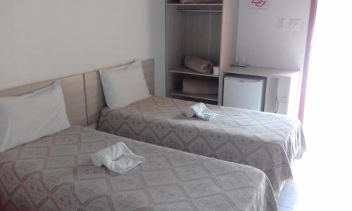 Tempat tidur dalam kamar di Hotel Pousada Gurupiá