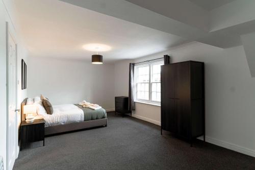 a bedroom with a bed and a window at Bright 1 Bed Harbour-side Apartment with Balcony in Whitehaven