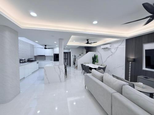 a living room with a couch and a table at Marble Manor - Elegant Landed house in Subang Jaya