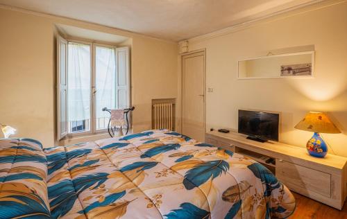 a bedroom with a bed and a flat screen tv at Teatro in Anghiari