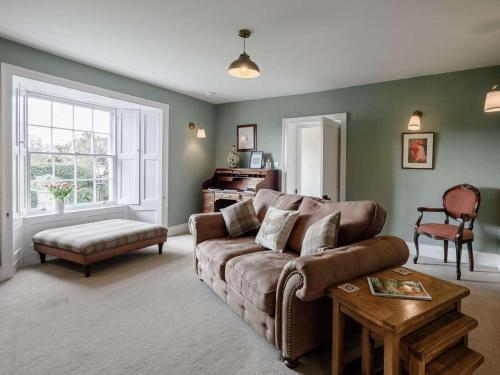 a living room with a couch and a table at 1 Bed in Bideford oc-51784 in Parkham
