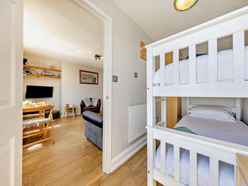 a bedroom with a bunk bed and a desk at 2 Bed in Aberdyfi oc-dy044 in Aberdyfi