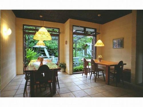a dining room with a table and chairs at Pension Iriomote in Iriomote
