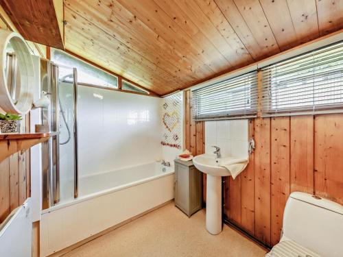 a bathroom with a sink and a tub and a toilet at 2 Bed in Aberdyfi oc-dy050 in Aberdyfi