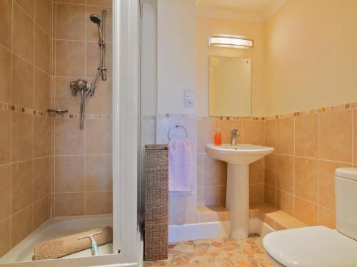 a bathroom with a shower and a sink and a toilet at 2 Bed in Bridport oc-dc015 in West Bay