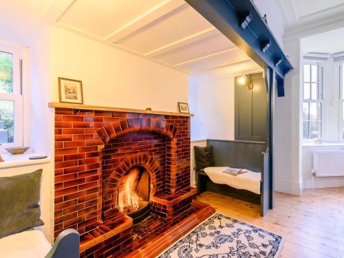 a brick fireplace in the middle of a living room at 7 Bed in Machynlleth oc-77466 in Aberllefenni