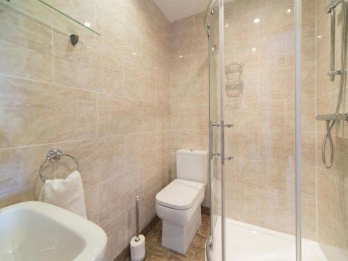 a bathroom with a shower and a toilet and a sink at 3 Bed in Shanklin oc-ic113 in Shanklin