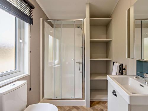a bathroom with a shower and a toilet and a sink at 2 Bed in Newport oc-94717 in Nevern