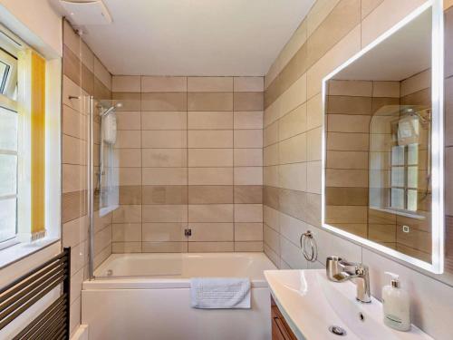 a bathroom with a tub and a sink at 2 Bed in Caernarfon oc-56989 in Clynnog-fawr