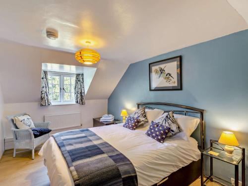 a bedroom with a bed and a chair and a window at 2 Bed in Caernarfon oc-56989 in Clynnog-fawr