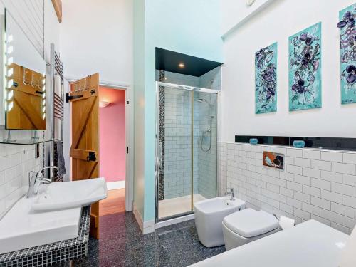 a bathroom with two sinks and a toilet and a shower at 3 Bed in Colwyn Bay oc-74146 in Eglwys-Fâch