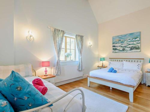 a bedroom with two beds and a window at 3 Bed in Colwyn Bay oc-74146 in Eglwys-Fâch