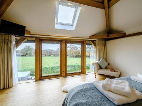 a bedroom with a bed and a large window at 1 Bed in South Molton oc-59339 in Knowstone