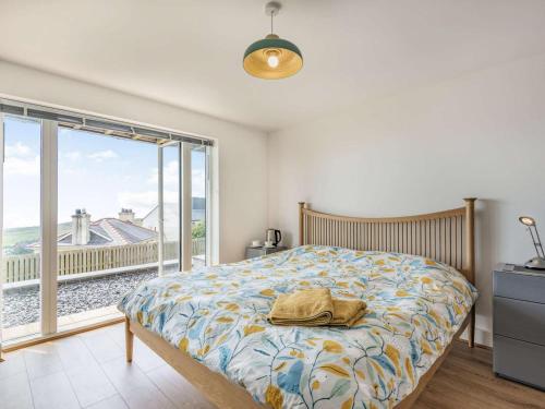 a bedroom with a bed and a large window at 4 Bed in Aberdovey oc-87586 in Aberdyfi