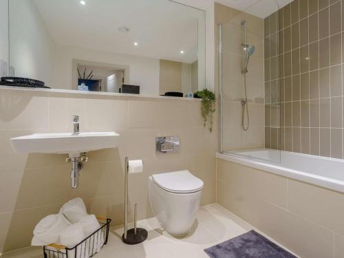 a bathroom with a toilet and a sink and a shower at 2 Bed in Porthcawl oc-89696 in Porthcawl