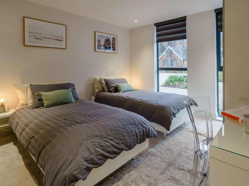 a bedroom with two beds and a window at 2 Bed in Porthcawl oc-89696 in Porthcawl