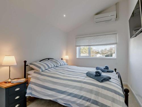 a bedroom with a bed with blue towels on it at 2 Bed in Brixham oc-90912 in Brixham