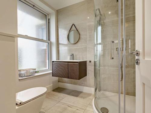 a bathroom with a shower and a toilet and a sink at 2 Bed in Woolacombe oc-90798 in Mortehoe