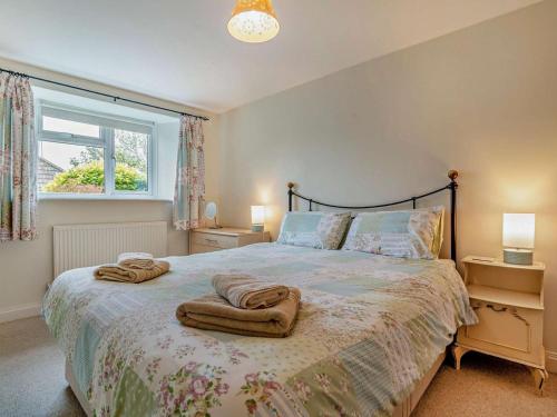 a bedroom with a bed with towels on it at 2 Bed in Bridport oc-94222 in Bridport
