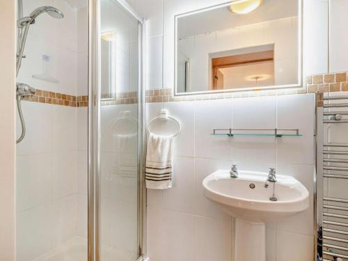 a white bathroom with a sink and a shower at 2 Bed in Bridport oc-94222 in Bridport