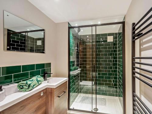 a bathroom with a glass shower and a sink at 2 Bed in Rhyl oc-94036 in Kinmel Bay