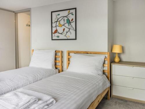 two beds in a bedroom with a picture on the wall at 3 Bed in Brixham oc-88116 in Brixham